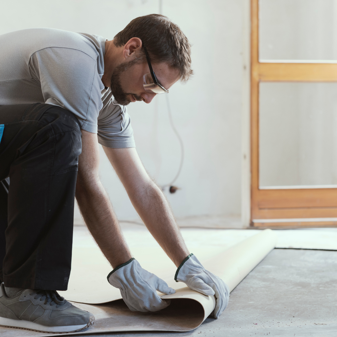 Man working installing carpets in a floor