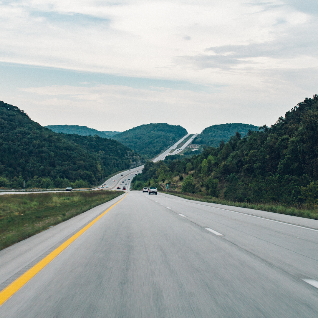 highway road with no cars and a mountain backdrop